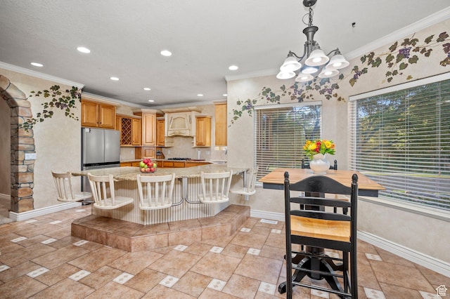 dining space with baseboards, a chandelier, recessed lighting, and crown molding