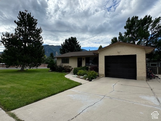 715 W 1600 N, Mapleton, UT 84664 - ranch-style home featuring concrete driveway, a garage, brick siding, a front yard, and a mountain view