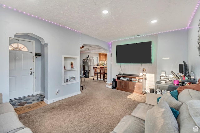 2778 S Cyprus Ln, Magna, UT 84044 - living area with baseboards, arched walkways, a textured ceiling, carpet floors, and recessed lighting