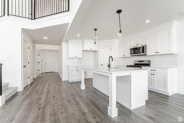 652 W Salvia Dr Unit 2144, Saratoga Springs, UT 84045 - kitchen with appliances with stainless steel finishes, a sink, recessed lighting, tasteful backsplash, and light wood-style flooring