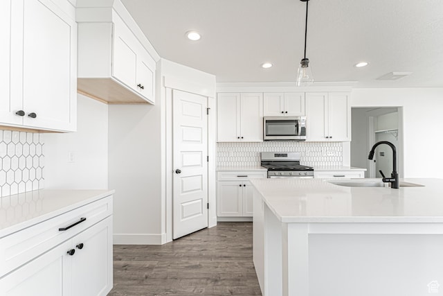 652 W Salvia Dr Unit 2144, Saratoga Springs, UT 84045 - kitchen with stainless steel appliances, a sink, dark wood-type flooring, white cabinetry, and recessed lighting