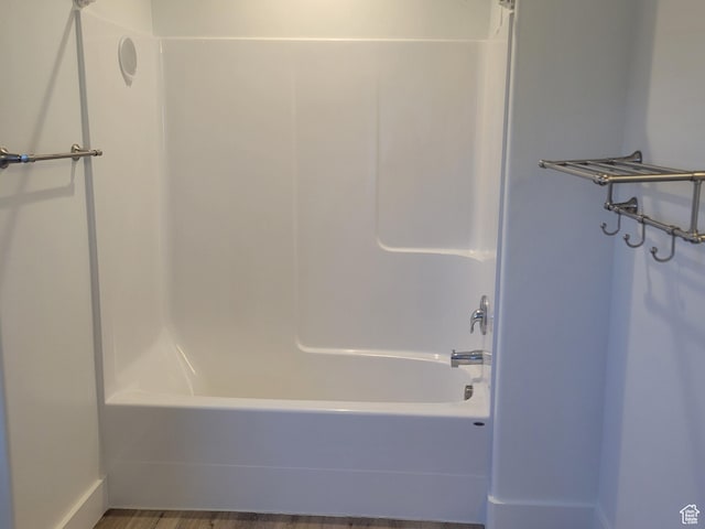 full bath featuring shower / bathtub combination and wood finished floors
