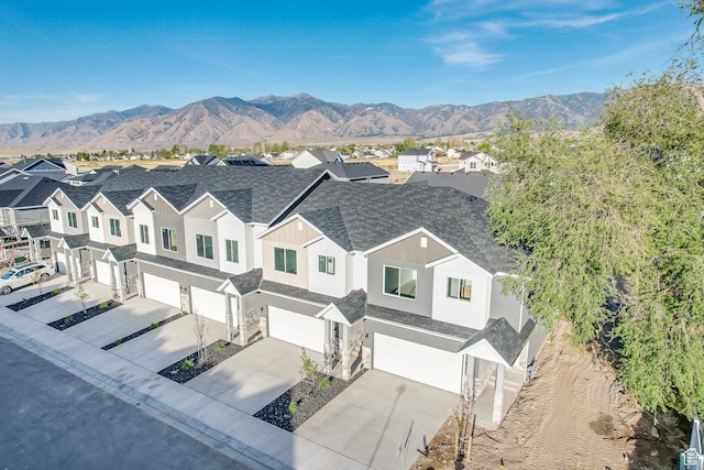birds eye view of property with a mountain view and a residential view
