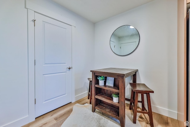interior space with baseboards and light wood-style flooring
