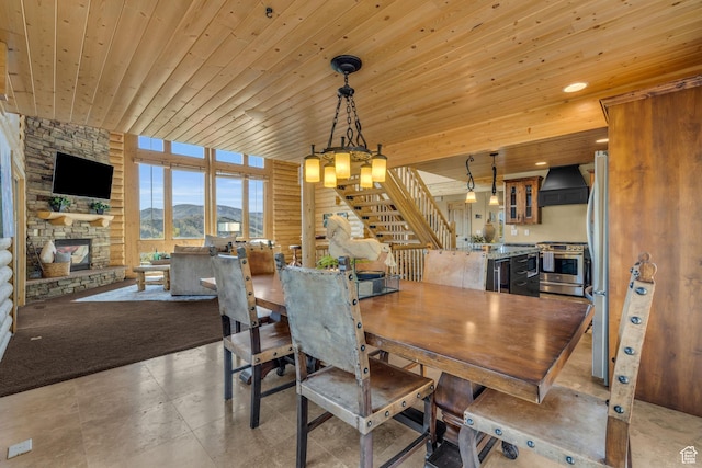 5404 Mountain Vw, Kamas, UT 84036 - dining area with a stone fireplace, a notable chandelier, wood ceiling, and stairway