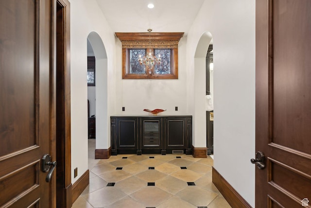 340 Hollyhock St, Park City, UT 84098 - corridor with an inviting chandelier, arched walkways, baseboards, and light tile patterned floors