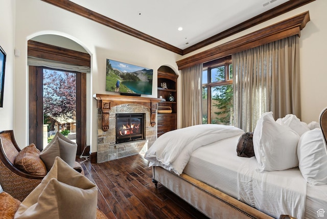 340 Hollyhock St, Park City, UT 84098 - bedroom with recessed lighting, a stone fireplace, ornamental molding, and dark wood-style floors