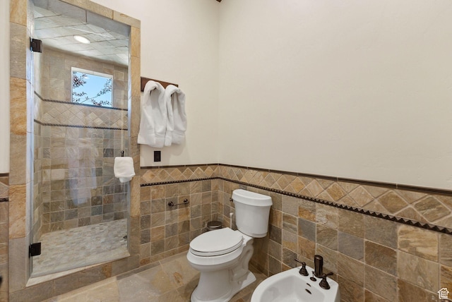 340 Hollyhock St, Park City, UT 84098 - bathroom featuring tile walls, toilet, a bidet, a shower stall, and wainscoting
