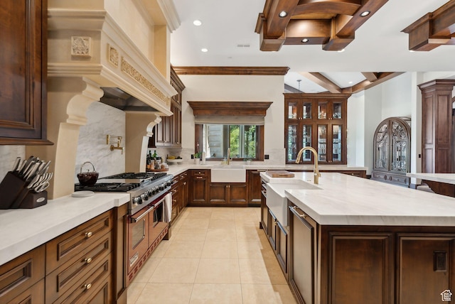 340 Hollyhock St, Park City, UT 84098 - kitchen with a sink, decorative backsplash, range with two ovens, and light tile patterned floors