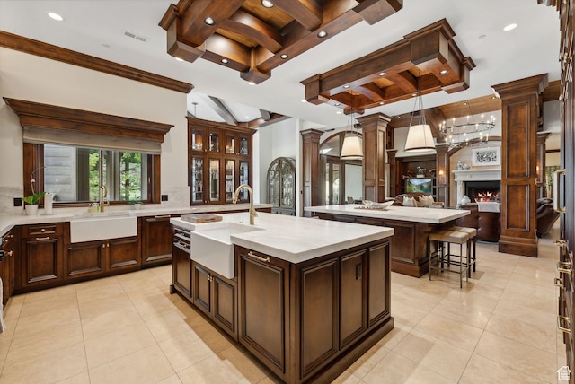 340 Hollyhock St, Park City, UT 84098 - kitchen with a sink, backsplash, beamed ceiling, and a center island with sink