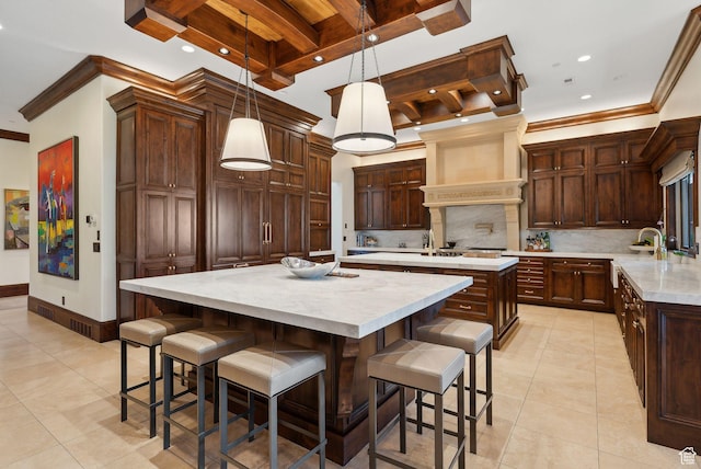 340 Hollyhock St, Park City, UT 84098 - kitchen featuring a large island, light tile patterned floors, ornamental molding, and backsplash