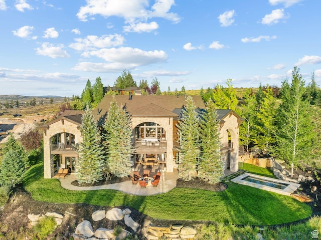 340 Hollyhock St, Park City, UT 84098 - rear view of house featuring a balcony, a patio area, an in ground hot tub, and a lawn