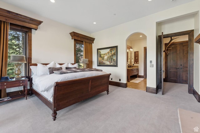 340 Hollyhock St, Park City, UT 84098 - bedroom featuring light colored carpet, arched walkways, and recessed lighting