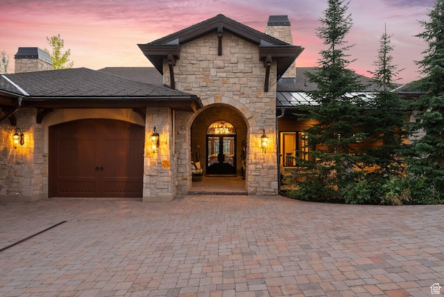 340 Hollyhock St, Park City, UT 84098 - view of front of house with a chimney, stone siding, french doors, and decorative driveway