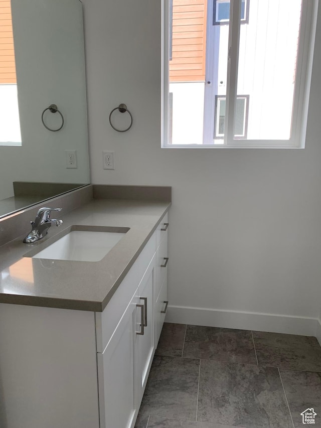 bathroom featuring vanity and baseboards