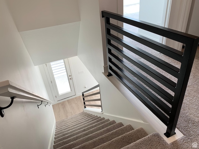 staircase with wood finished floors