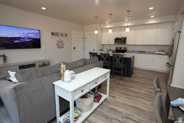 553 S 100 W Unit 203, Richfield, UT 84701 - living room featuring light wood-type flooring and recessed lighting
