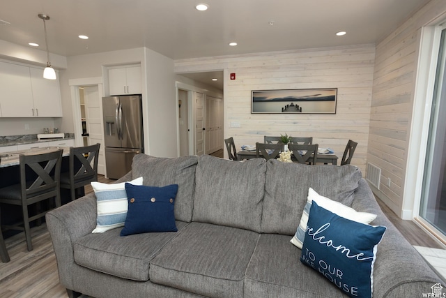 553 S 100 W Unit 203, Richfield, UT 84701 - living room featuring light wood finished floors, recessed lighting, and wooden walls
