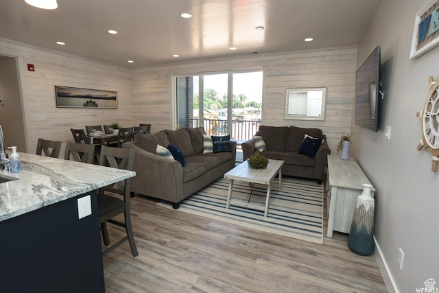 553 S 100 W Unit 203, Richfield, UT 84701 - living room with wood walls, recessed lighting, and light wood-type flooring