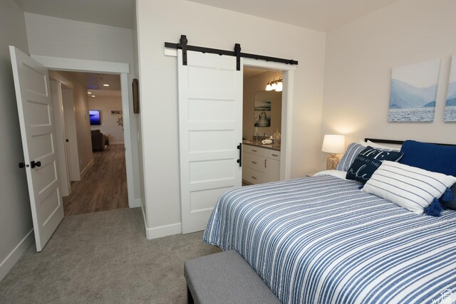 553 S 100 W Unit 203, Richfield, UT 84701 - carpeted bedroom with a barn door and ensuite bathroom