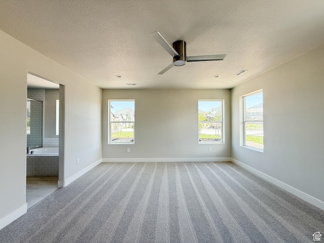 1546 S Lukas Ln, Saratoga Springs, UT 84045 - carpeted empty room featuring healthy amount of natural light, a textured ceiling, and a ceiling fan