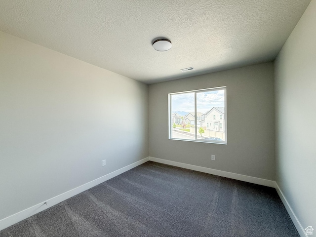 1546 S Lukas Ln, Saratoga Springs, UT 84045 - empty room featuring dark colored carpet and a textured ceiling