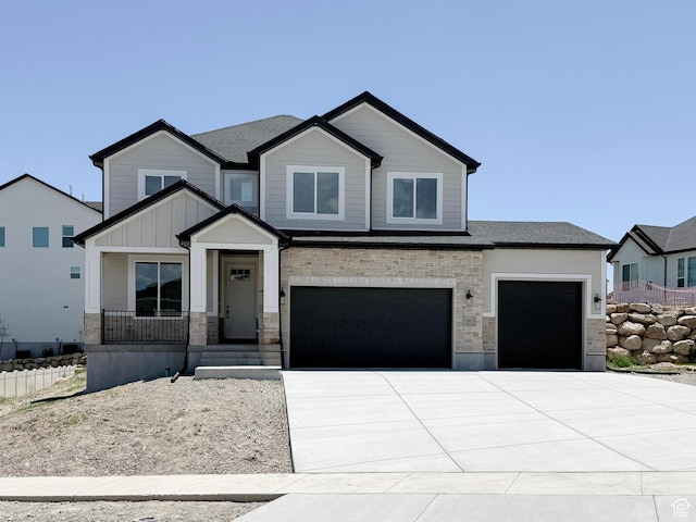 1546 S Lukas Ln, Saratoga Springs, UT 84045 - view of front of home with driveway, stone siding, a garage, and an attached garage