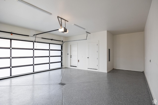 garage featuring baseboards and a garage door opener