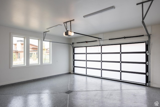 garage with baseboards and a garage door opener