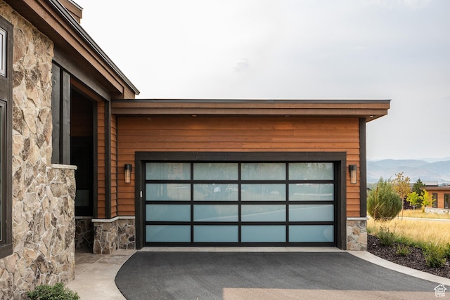 garage featuring a mountain view and aphalt driveway