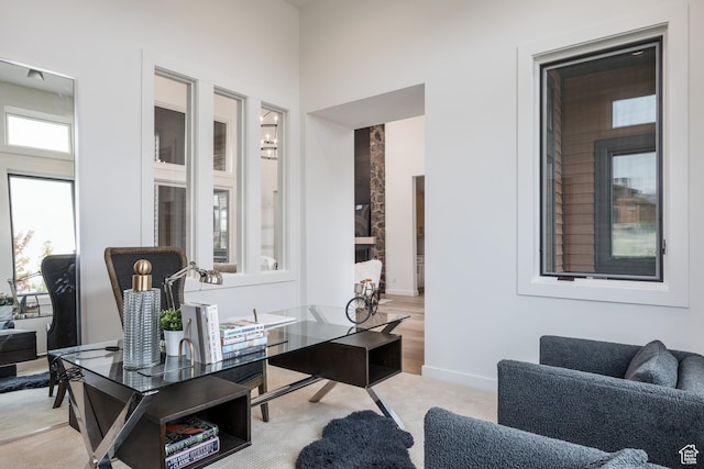 office space featuring baseboards and light carpet