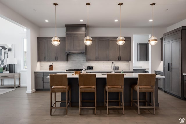 838 N Burro Peak Cir, Heber City, UT 84032 - kitchen featuring a sink, tasteful backsplash, light countertops, a kitchen island with sink, and premium range hood