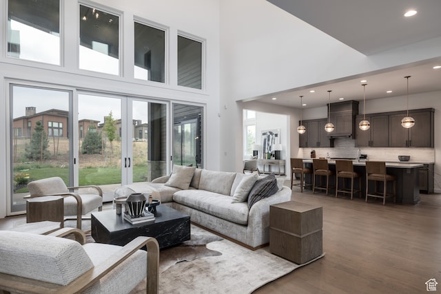living room featuring a wealth of natural light, a high ceiling, and hardwood / wood-style flooring