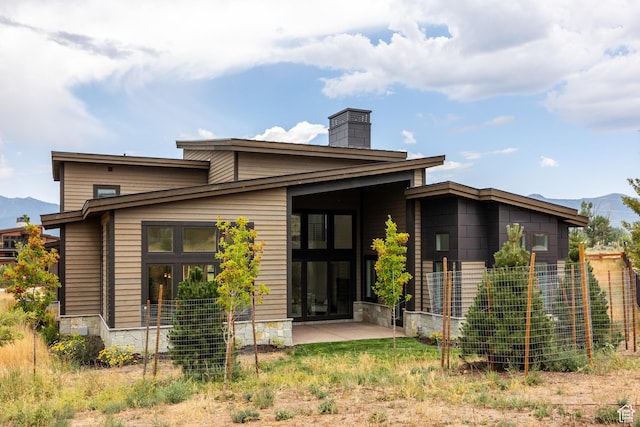 838 N Burro Peak Cir, Heber City, UT 84032 - back of house with a mountain view, a chimney, and stone siding