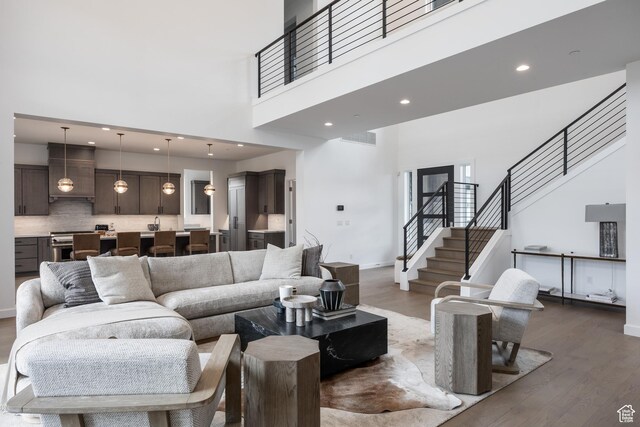838 N Burro Peak Cir, Heber City, UT 84032 - living area with a high ceiling, dark wood-style flooring, stairs, baseboards, and recessed lighting
