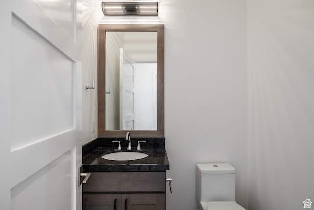 bathroom with toilet and vanity