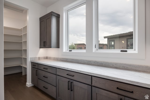 interior space featuring dark hardwood / wood-style flooring and light stone countertops