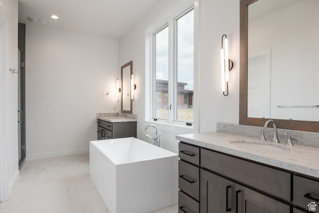 bathroom with vanity and separate shower and tub