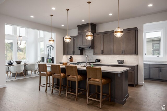 838 N Burro Peak Cir, Heber City, UT 84032 - kitchen with wood finished floors, decorative backsplash, a breakfast bar area, and recessed lighting