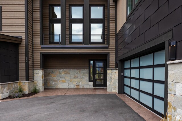 838 N Burro Peak Cir, Heber City, UT 84032 - doorway to property with stone siding, a garage, and asphalt driveway