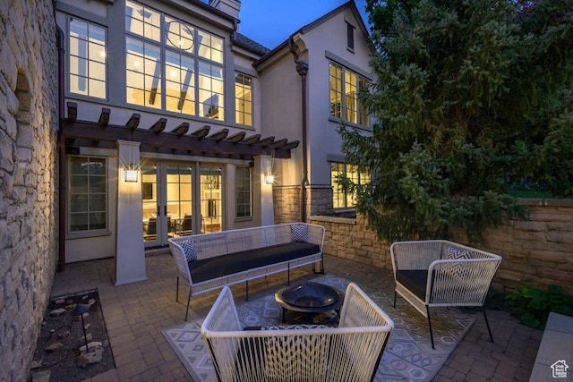 view of patio / terrace with a pergola and an outdoor living space with a fire pit