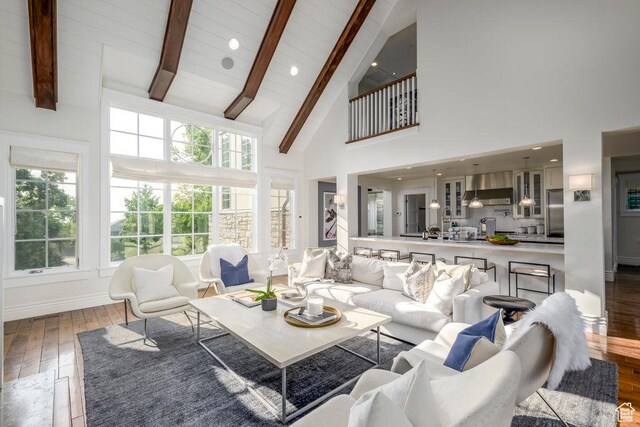 living room featuring high vaulted ceiling, baseboards, recessed lighting, beam ceiling, and wood-type flooring