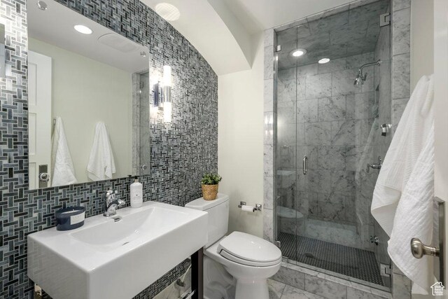 1137 S Douglas St E, Salt Lake City, UT 84105 - bathroom with a shower stall, marble finish floor, toilet, vanity, and backsplash