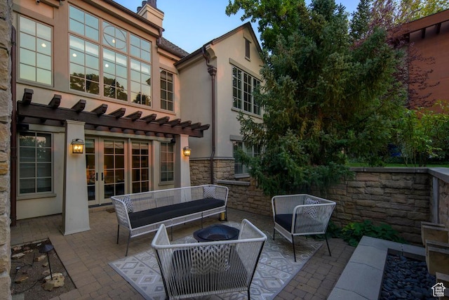 view of patio / terrace with a pergola, an outdoor hangout area, and french doors