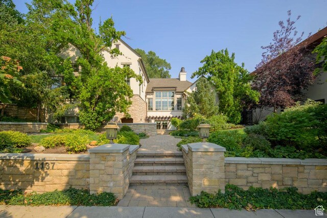 1137 S Douglas St E, Salt Lake City, UT 84105 - view of front facade featuring stucco siding and a chimney