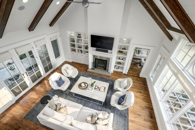 1137 S Douglas St E, Salt Lake City, UT 84105 - living area featuring beam ceiling, high vaulted ceiling, a glass covered fireplace, and wood finished floors