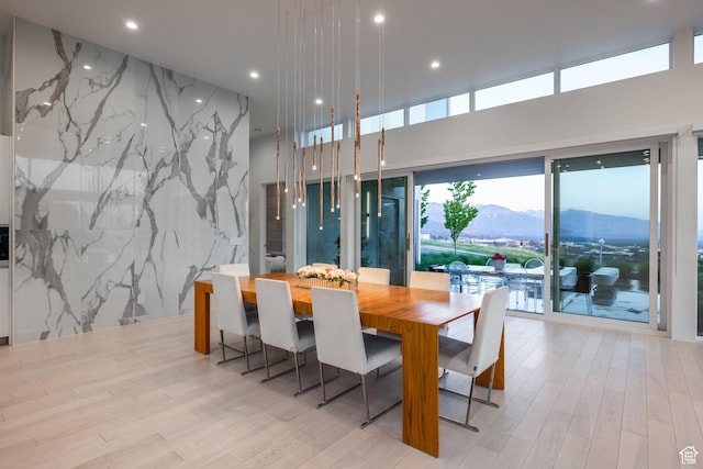 405 N Virginia St, Salt Lake City, UT 84103 - dining room with stone wall, recessed lighting, wood finished floors, and a mountain view