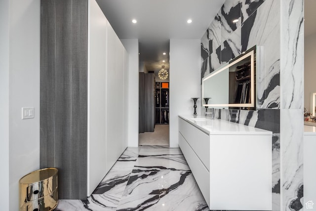 405 N Virginia St, Salt Lake City, UT 84103 - interior space featuring vanity, stone wall, recessed lighting, and marble finish floor