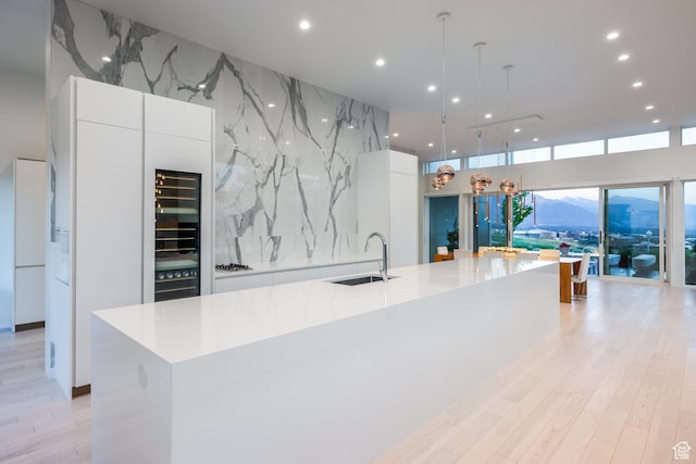 405 N Virginia St, Salt Lake City, UT 84103 - kitchen with a sink, a spacious island, modern cabinets, and white cabinetry
