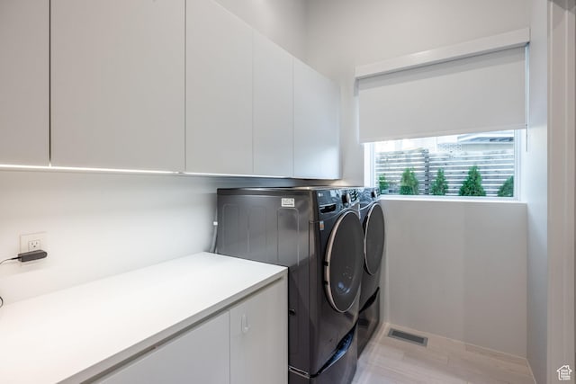 405 N Virginia St, Salt Lake City, UT 84103 - clothes washing area featuring separate washer and dryer, cabinet space, and visible vents